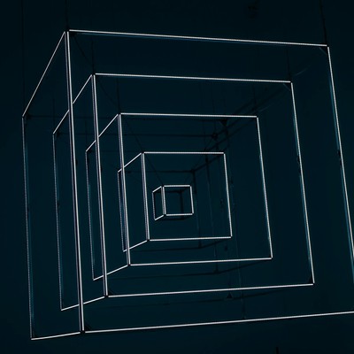 Dynamic abstract design with glowing neon cubes creating depth and perspective.